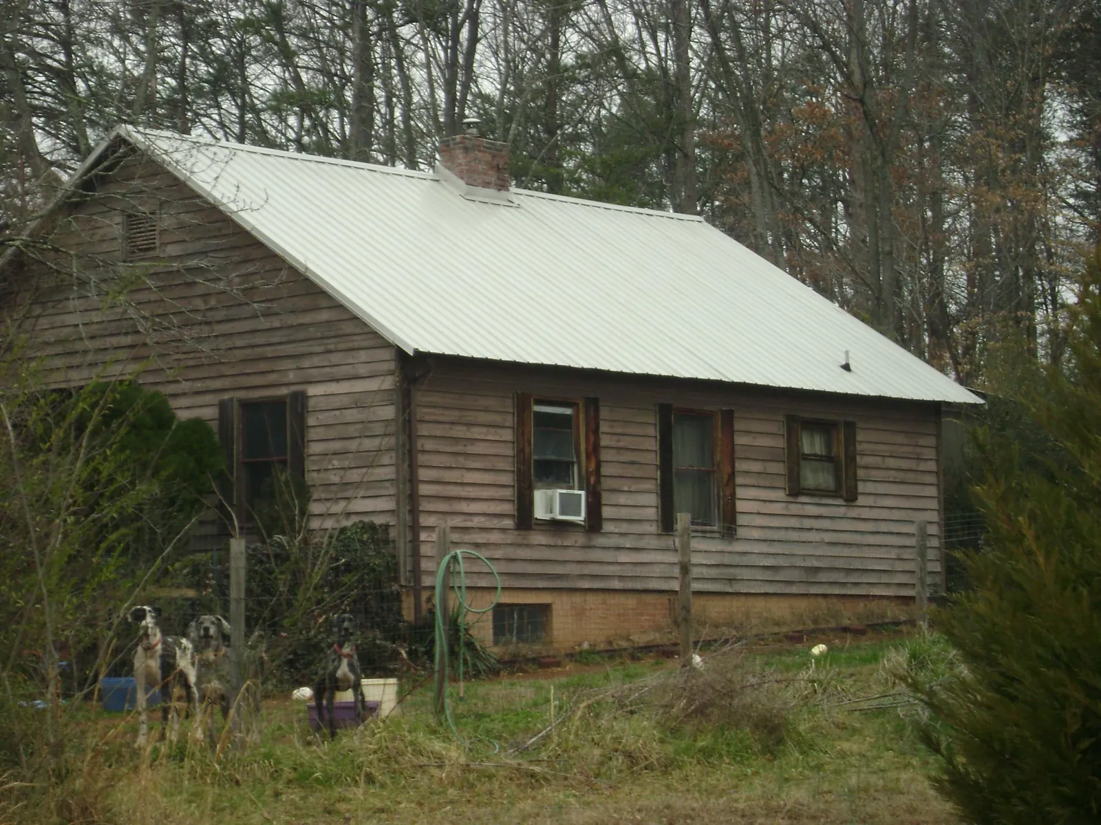 White metal roof on an old wood sided farmhouse, from a Metal Roof Installation job in Beulah